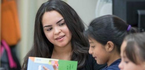 RIC student teacher with elementary students