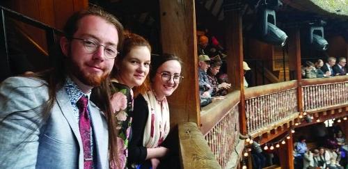 3 students seated in the balcony of a theater